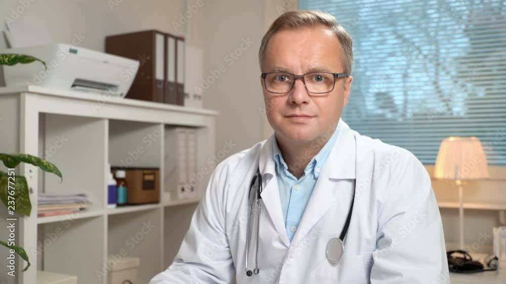 Medicine online. Male doctor advises patient using video chat showing the test results Medicine online. Male doctor advises patient using video chat showing the test results