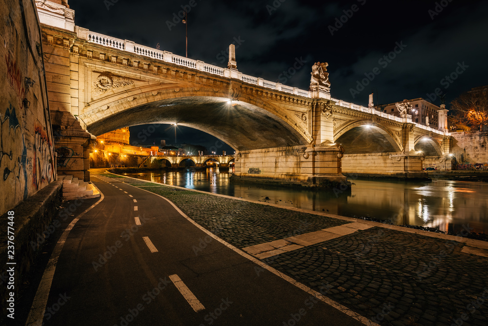 Fototapeta premium Bike path along the Tiber and Ponte Vittorio Emanuele II, in Rome, Italy.