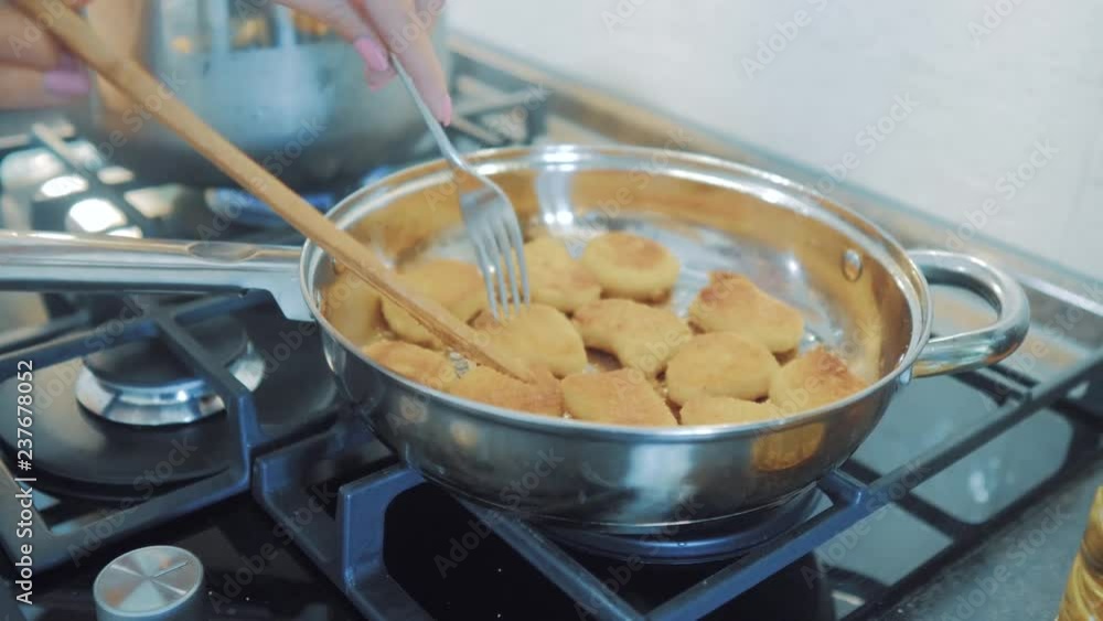 chef hand fry stir in a pan chicken nuggets tempura in to hot oil pan