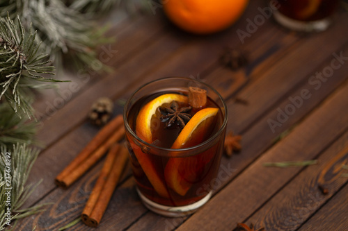 Christmas mulled red wine with spices on a wooden rustic table. Traditional hot drink at Christmas time