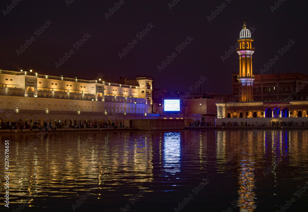 Minaret at the side of golden temple with large display