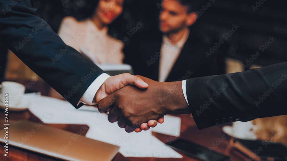 Close Up of Business Handshake in Restaurant Close Up of Business Handshake in Restaurant