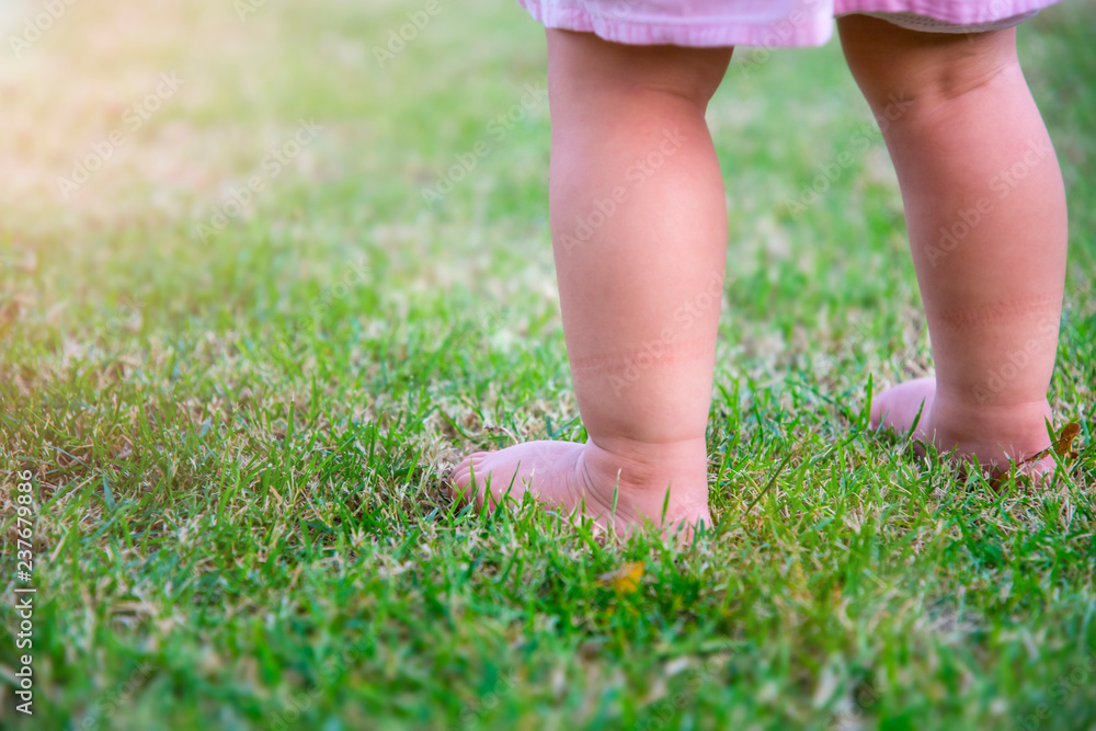 Leg little girl play big ball  in the garden , Nature concept