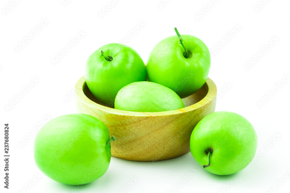 apple monkey or jujub (Zizyphus mauritiana Lam) isolated green fruit in wooden cup on white background and clipping path. apple monkey or jujub (Zizyphus mauritiana Lam) isolated green fruit in wooden cup on white background and clipping path.