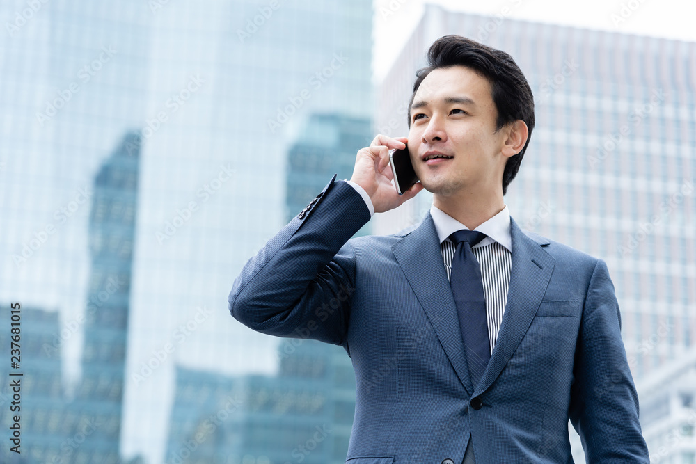 portrait of young asian business person standing in
front of building portrait of young asian business person standing in
front of building