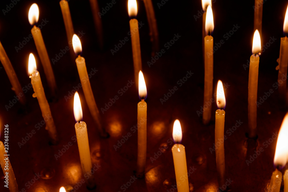 Group of burning candles in dark