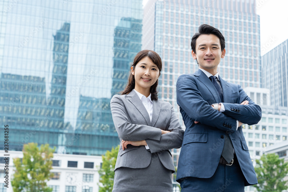 portrait of young asian business person standing in
front of building portrait of young asian business person standing in
front of building