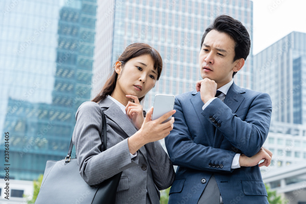 portrait of young asian business person standing in
front of building portrait of young asian business person standing in
front of building