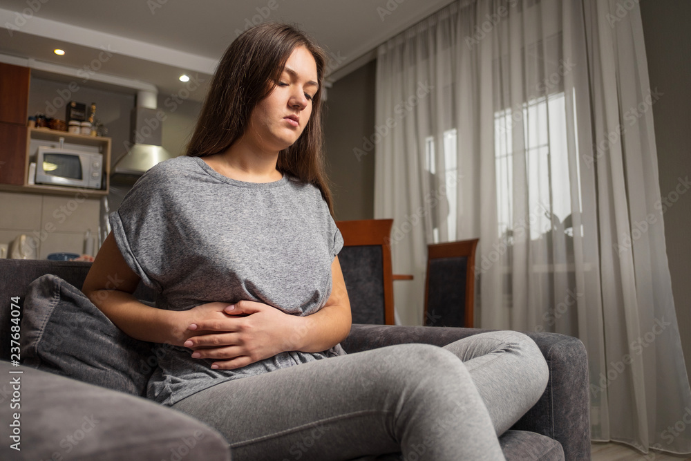 young woman has pain in right hypochondrium, young woman has a stomachache, gallbladder disease young woman has pain in right hypochondrium, young woman has a stomachache, gallbladder disease