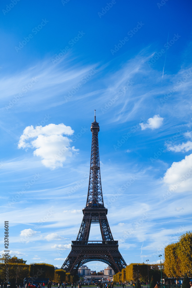 Eiffel tower on blue sky and yellow foliage background