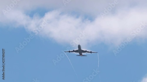 Giant plane in the air descending and lining up with the runway before landing. photo