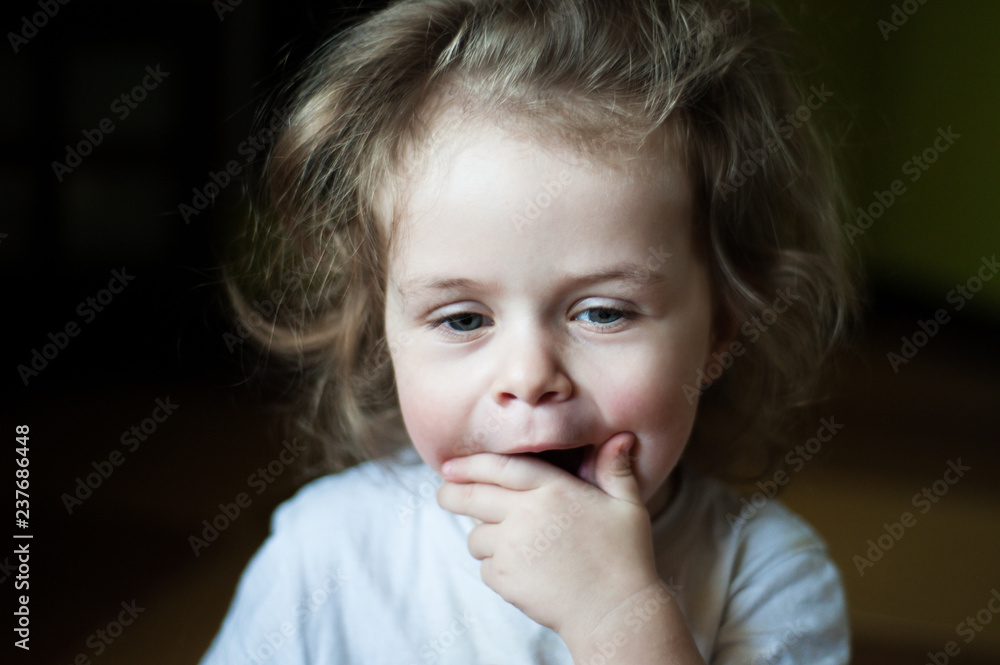 Closeup portrait of a child. She yawns and covers her mouth. Shaggy girl. Emotional concept Closeup portrait of a child. She yawns and covers her mouth. Shaggy girl. Emotional concept