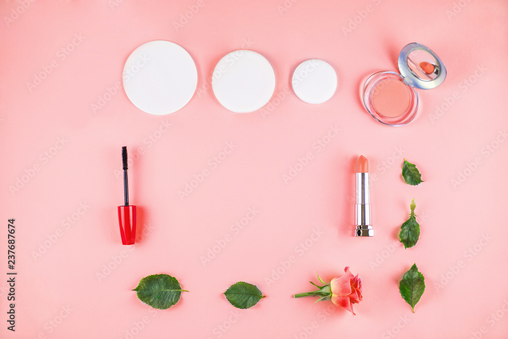 Naklejka premium Flat lay composition with lipstick, mascara, flowers.