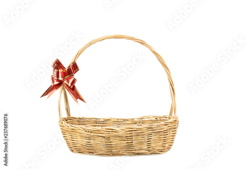 Empty wicker basket with red and gold ribbon isolated on white background
