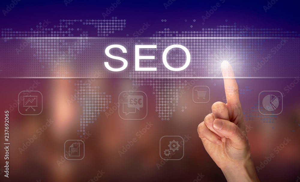 A hand selecting a SEO business concept on a clear screen with a colorful blurred background. A hand selecting a SEO business concept on a clear screen with a colorful blurred background.