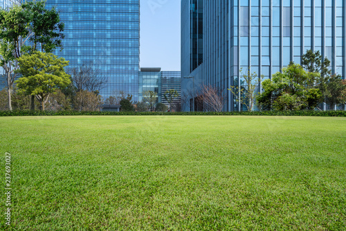 beautiful green field near modern office building.