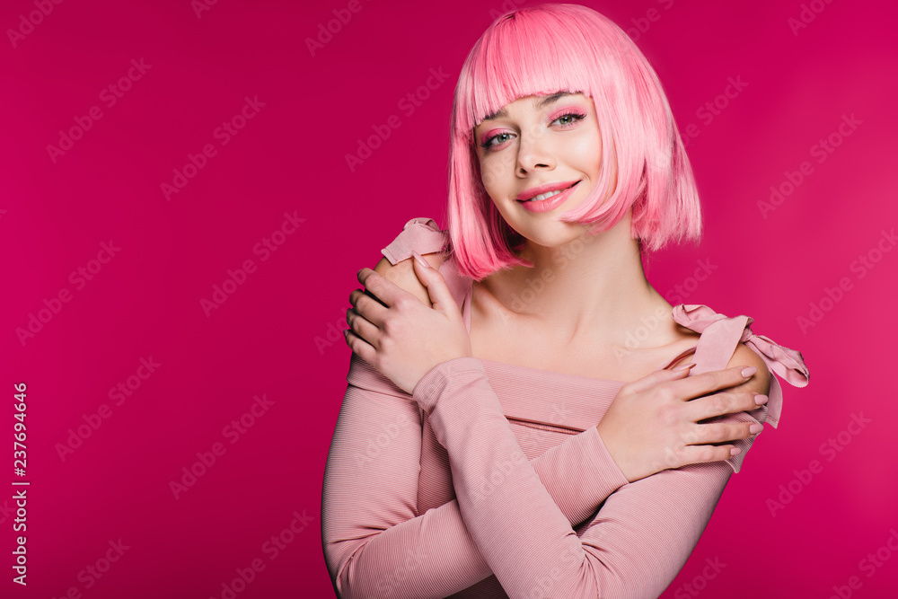 Fototapeta premium beautiful stylish girl posing in pink wig, isolated on pink