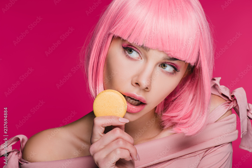 attractive sensual girl in pink wig posing with macaron isolated on pink attractive sensual girl in pink wig posing with macaron isolated on pink