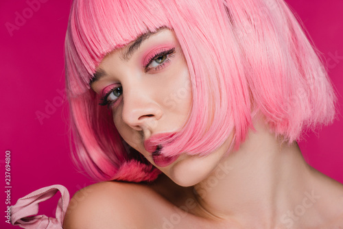 beautiful sensual girl posing in pink wig, isolated on pink
