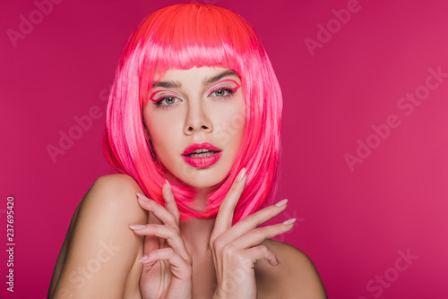 beautiful naked model posing in neon pink wig, isolated on pink