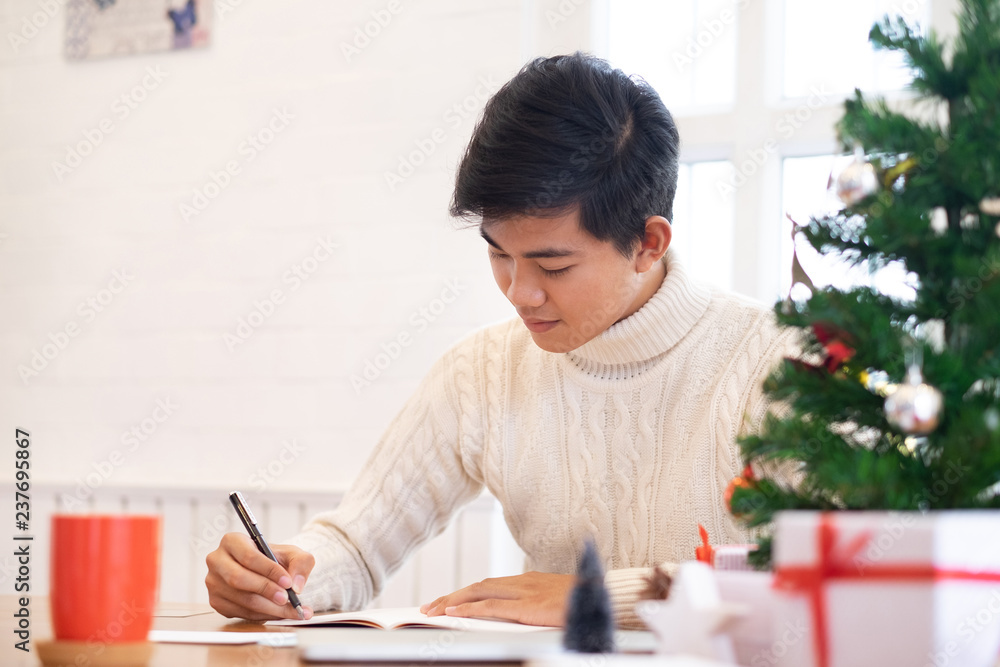 Man writing christmas and new year greeting cards.. Man writing christmas and new year greeting cards..