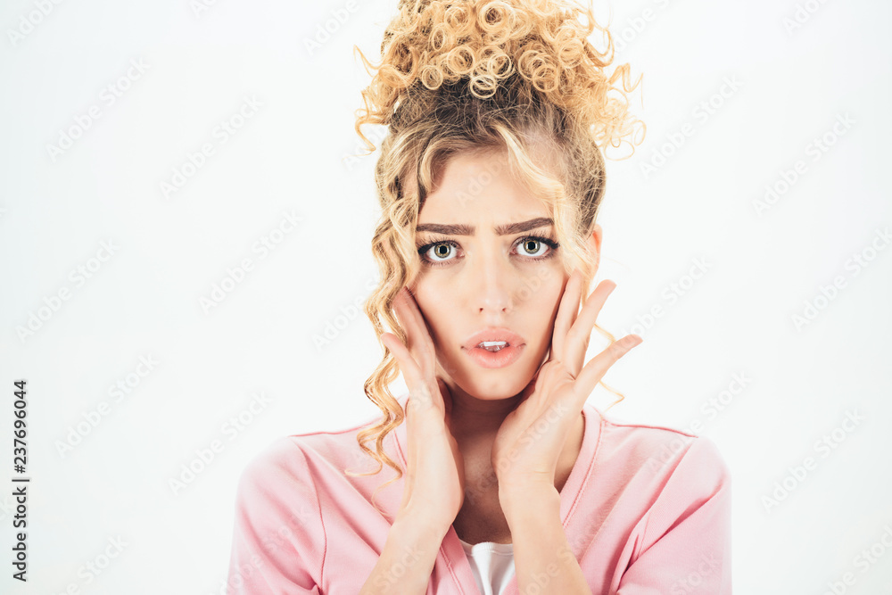 Beautiful emotional woman with healthy curly blonde hair. Surprised amazed beautiful woman with curly hairstyle, makeup. Surprised girl holds cheeks by hand. Beautiful woman model with curly hairstyle Beautiful emotional woman with healthy curly blonde hair. Surprised amazed beautiful woman with curly hairstyle, makeup. Surprised girl holds cheeks by hand. Beautiful woman model with curly hairstyle