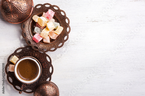 Traditional Turkish coffee and Turkish delight on white shabby wooden background. Top view. photo