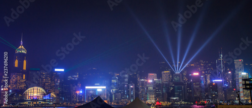 View Night of Symphony of Lights and two boat of life at Victoria Harbor in Hong Kong.