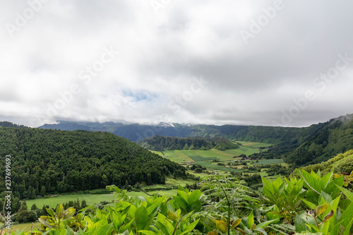 Green summer view of the Seca caldera in the distance on Sao Miguel, Azores.