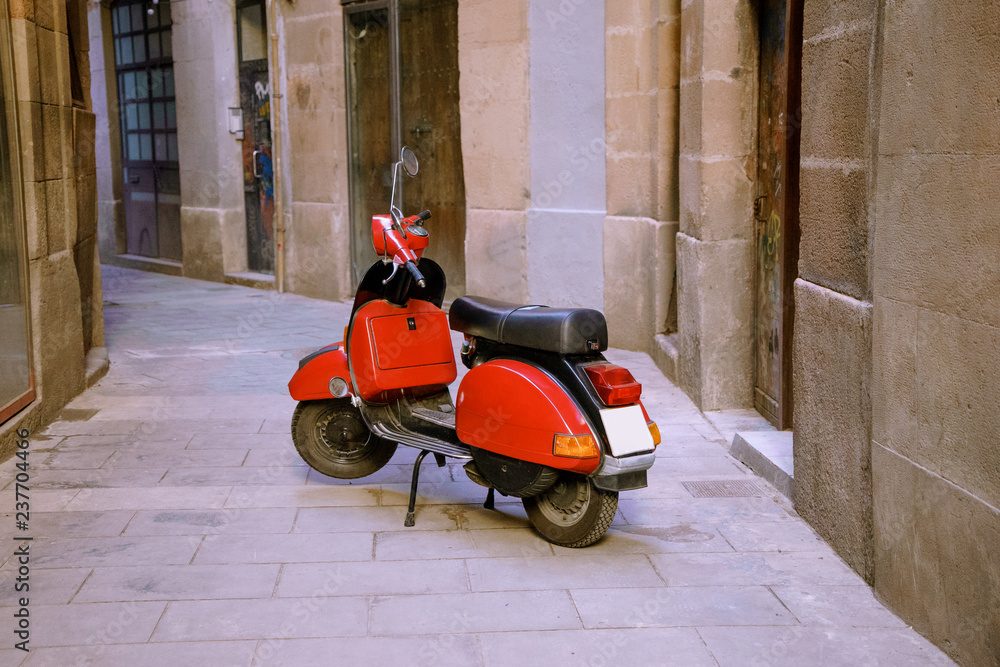 Red retro scooter on street