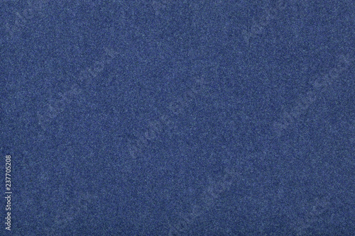 Navy blue matt suede fabric closeup. Velvet texture of felt.