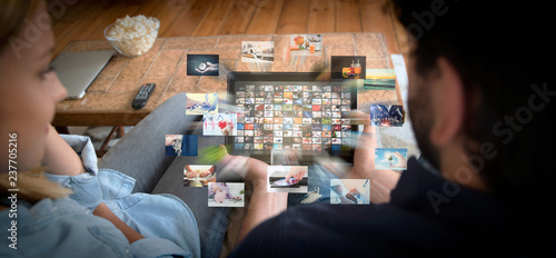 Couple using tablet for watching VOD service photo