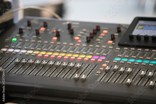The audio equipment, control panel of digital studio mixer, side view. Close-up, selected focus