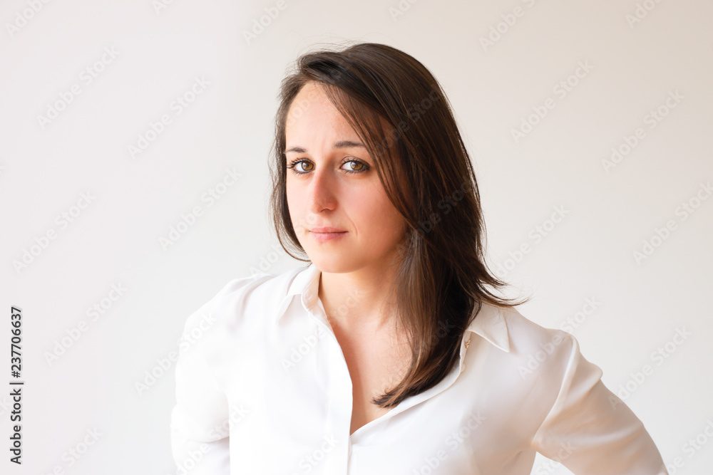 Attractive office worker in white blouse looking at camera. Portrait of beautiful young manager. Isolated on white. Beauty concept Attractive office worker in white blouse looking at camera. Portrait of beautiful young manager. Isolated on white. Beauty concept