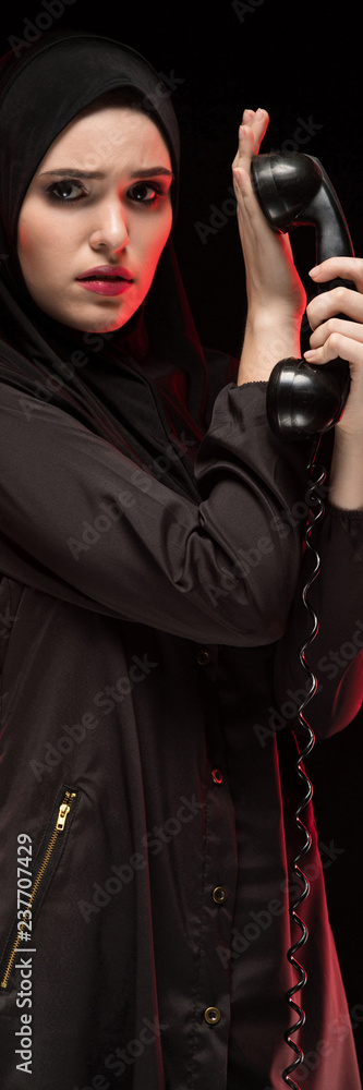 Portrait of woman with telephone against black background Portrait of woman with telephone against black background
