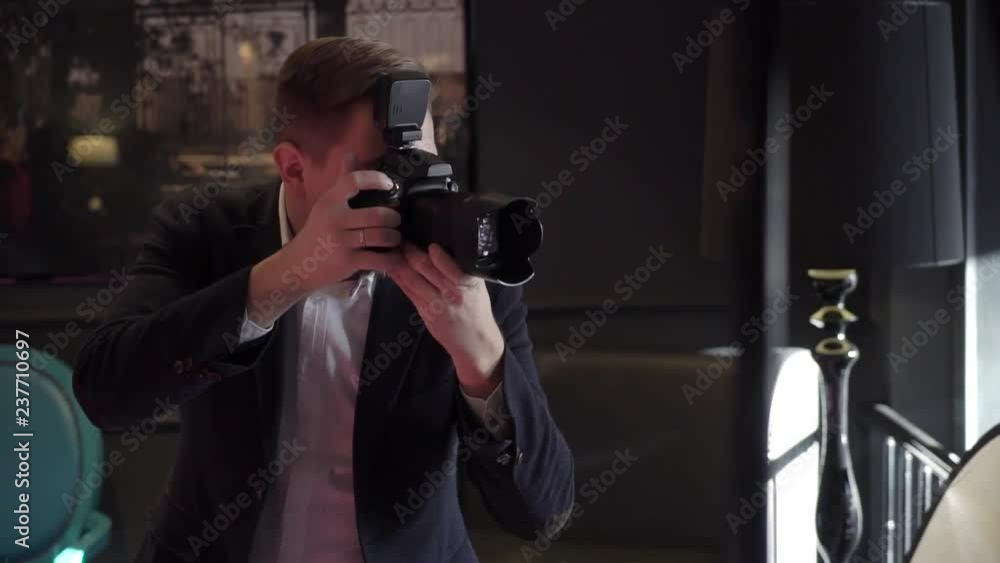 Professional photo shooting indoors. Photographer is taking pictures photos with a digital camera DSLR. Photosession Professional photo shooting indoors. Photographer is taking pictures photos with a digital camera DSLR. Photosession