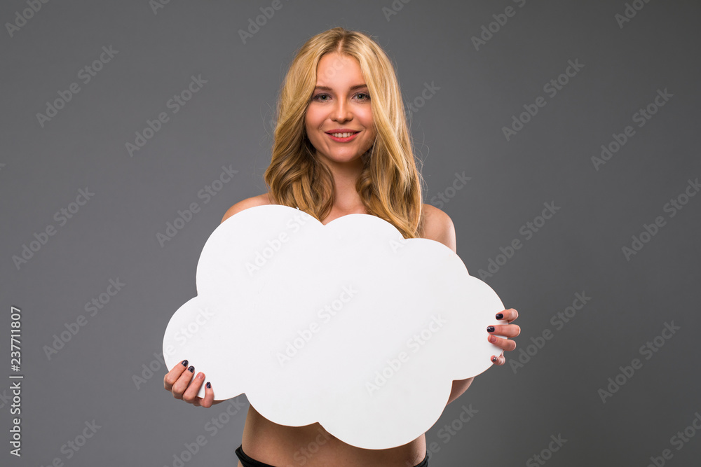 beautiful girl holding a cardboard white cloud, isolated gray background beautiful girl holding a cardboard white cloud, isolated gray background