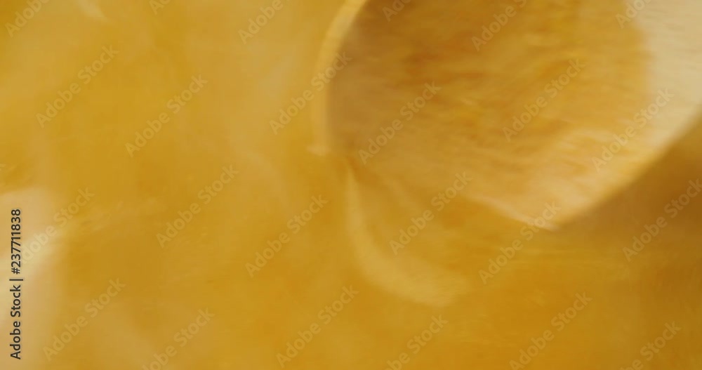 Very close video of steaming hot butternut squash soup being stirred vigorously with a wood spoon in a pan illuminated with natural light. Very close video of steaming hot butternut squash soup being stirred vigorously with a wood spoon in a pan illuminated with natural light.