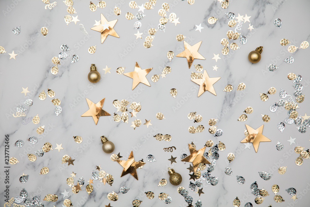 Gold star sparkle party confetti on a marble flat lay background - obrazy, fototapety, plakaty 