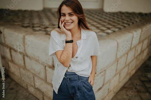 Portrait of young woman with blond hair standing outdoors