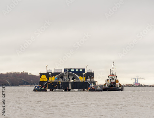 Bild auf Leinwand A giant tidal turbine being delivered for installation on the ocean floor