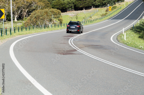 Large blood stain on rural road after wildlife roadkill © Adam