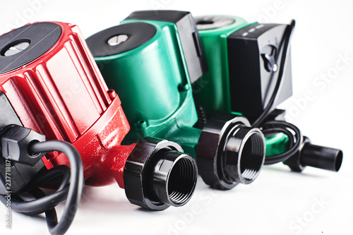 Fotografi Red and green circulation pumps for heating on a white background