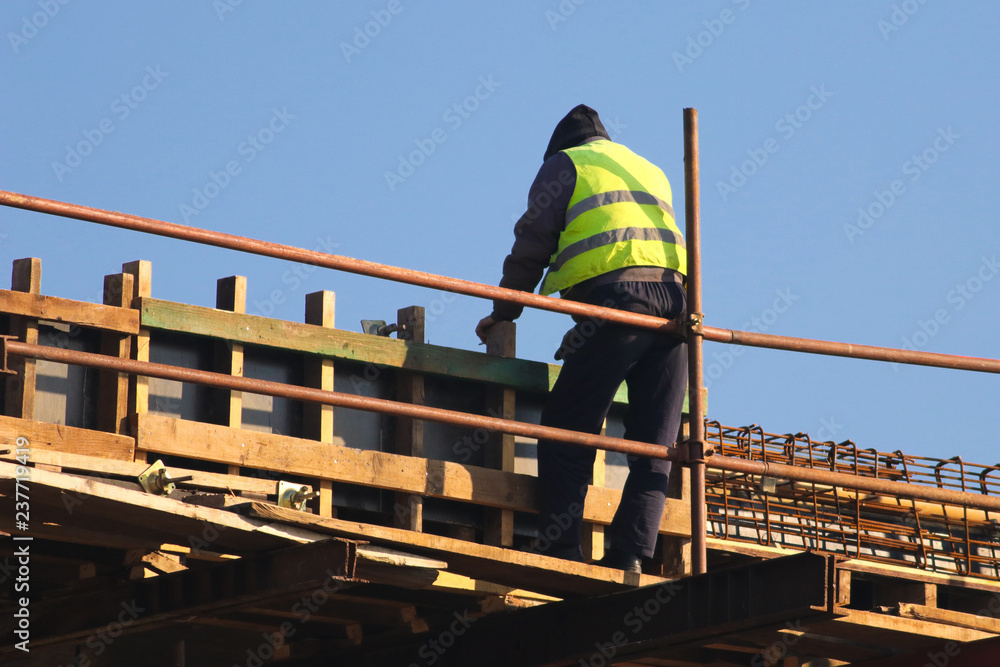 Naklejka premium Safety risc worker without helmet at the construction site
