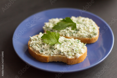sandwiches with cottage cheese and herbs on a blue plate