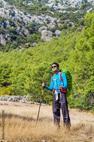 A purposeful man on a mountain trail. Enjoy nature and fresh air on a trekking route.Mountaineering in Turkey. A solo hiking journey. © Ольга Ким