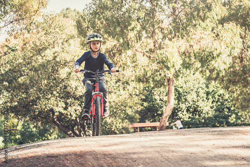 Australian boy riding his bicycles on special bike track in Adelaide, South Australia. Low point photo
