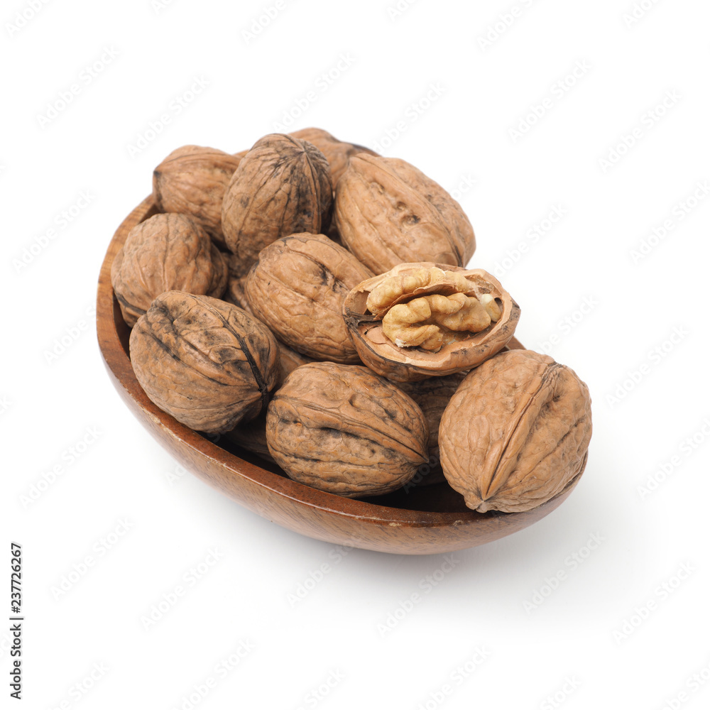 Organic French walnuts in a wooden bowl Organic French walnuts in a wooden bowl