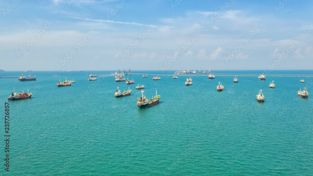 Oil tanker, gas tanker in the high sea.Refinery Industry cargo ship,aerial view,Thailand, in import export, LPG,oil refinery, Logistics and transportation with working crane bridge in harbor