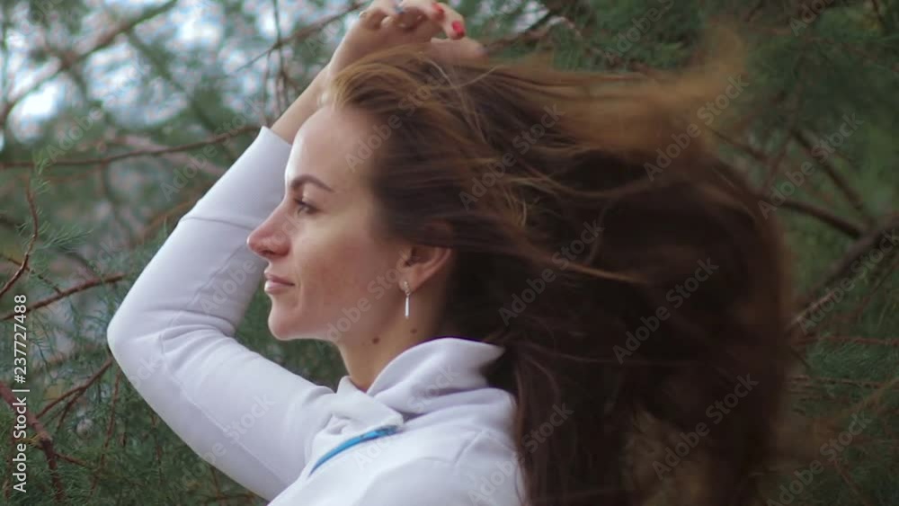Close Up Portrait of Woman Standing on the Wind. Breeze is playing with girls hair. Stormy weather, autumn, winter, spring. Close Up Portrait of Woman Standing on the Wind. Breeze is playing with girls hair. Stormy weather, autumn, winter, spring.